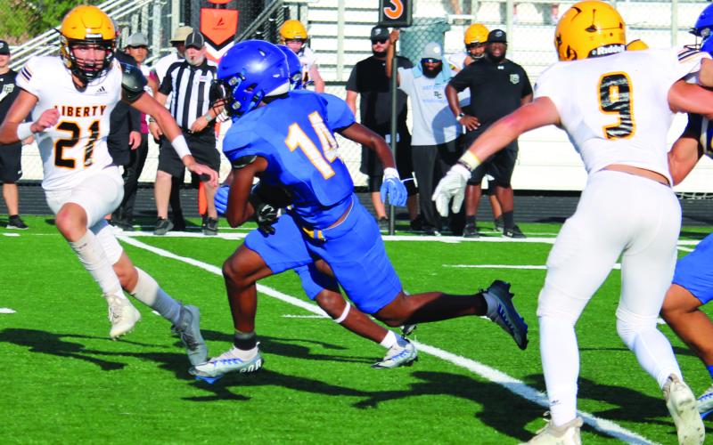 Sentinel Photo/Mike Reddell Above, senior Blackcat running back Paris Fox (14) picks up yardage against Liberty in the scrimmage here Friday, Aug. 11.
