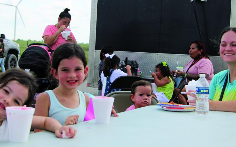 Sentinel Photo/Mike Reddell About 200 backpacks were given away at the Peyton Creek Wind Farm Annual School Supply Drive Tuesday, Aug. 8. In addition to the backpacks, Peyton Creek provided Texas Best Snowballs and Full Moon Wood Fired Pizza. Above, Jade Fox of Bay City, with her three children, from left, at Peyton Creek: Phoenix, 3, Lyra, 5, and Nova, 1.