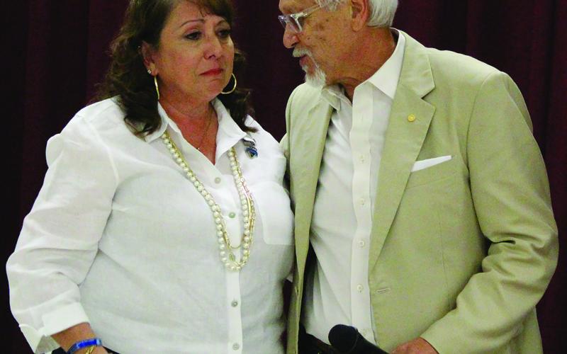 Sentinel Photo/Jessica Shepard Cynthia “Cindy” Delgado is shown with District Attorney Steven Reis as the 100 Club presented the widow of BCPD officer Juan Delgado with a $20,000 check from the club.