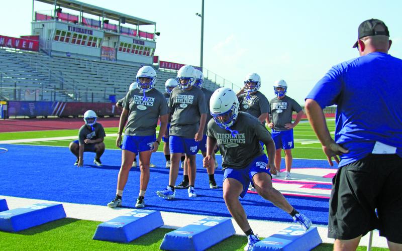 Anna Hernandez photo A Tidehaven coach watches as players go through an agility drill last week.