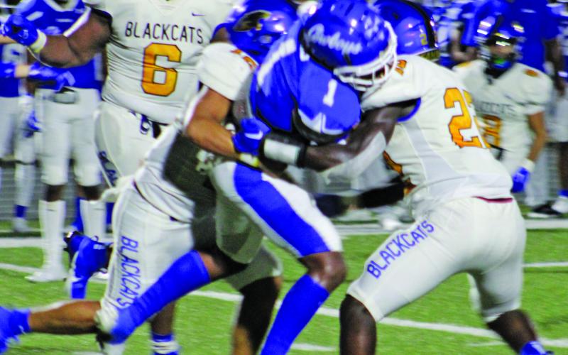 Sentinel Photo/Mike Reddell A host of Bay City defenders close in on an Edna running back at last Friday’s game. Rushing to join the squeeze play was senior Carlon Jones (6).