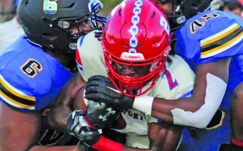 Sentinel Photo/Mike Reddell Blackcat senior Carlon Jones (6) and sophomore Damon Harkins (45) stop a Brazosport runner.