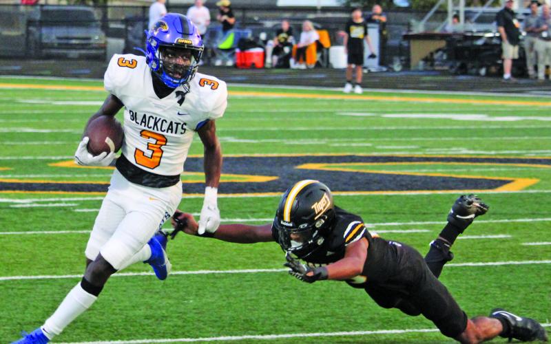 Sentinel Photo/Mike Reddell Blackcat junior Mack Curtis (3) rounds end for several  yards.