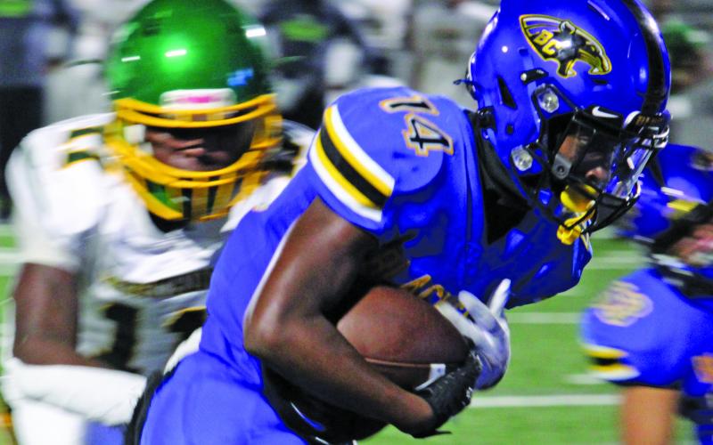 Sentinel Photo/Mike Reddell Senior Bay City running back Paris Fox (14) charges ahead to gain yardage against Worthing here Friday night, Sept. 8.