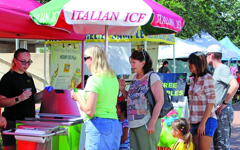While Saturday was officially the first day of fall, it didn’t feel like autumn with temperatures in the mid to high 90s. These folks at Saturday’s Market Day lined up for something cool. Sentinel Photo Jessica Shepard