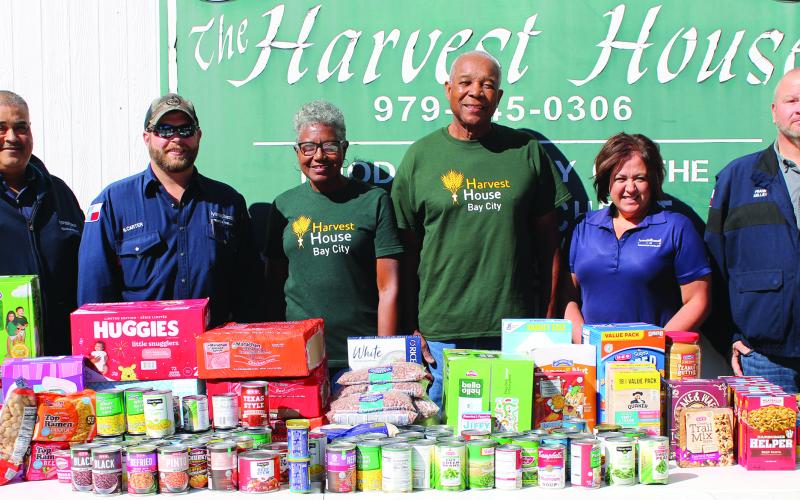 Sentinel Photo/Jessica Shepard As part of its "Global Care Day," several LyondellBasell employees brought a generous food and personal care item and monetary donation to Bay City's Harvest House food pantry, on Monday, Oct. 16. The company chose to focus its care efforts in conjunction with "World Food Day" to combat food insecurities in communities across the world.