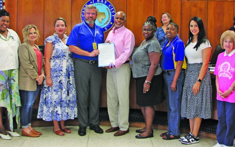 Sentinel Photo/Mike Reddell City Council last week approved a proclamation recognizing October 5, 2023, as "Bay City Teachers' Day." At the center of photo, Bay City ISD Superintendent Dwight McHazlett (left) and Mayor Robert Nelson show off the proclamation.