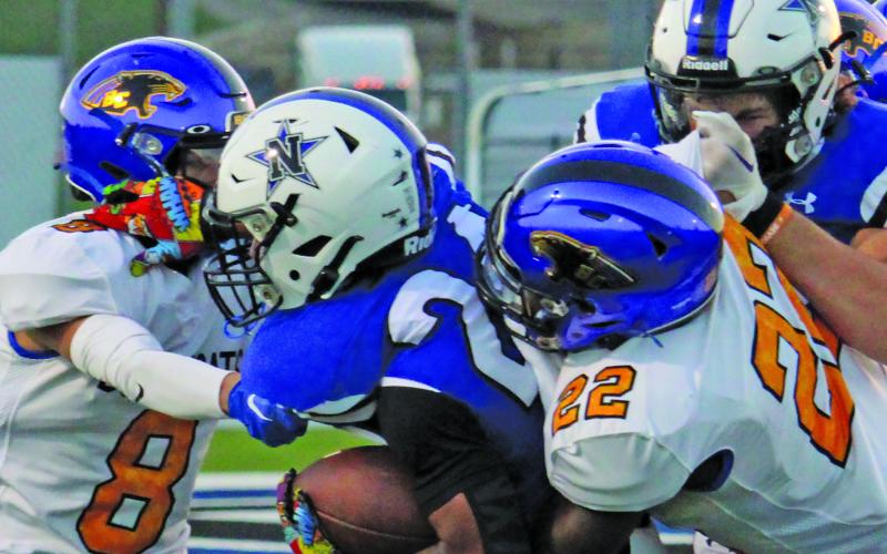 Sentinel Photo/Mike Reddell Senior defensive back Elijah Hernandez (8) and sophomore linebacker James Copeland (22) put a stop to a Navasota running back.