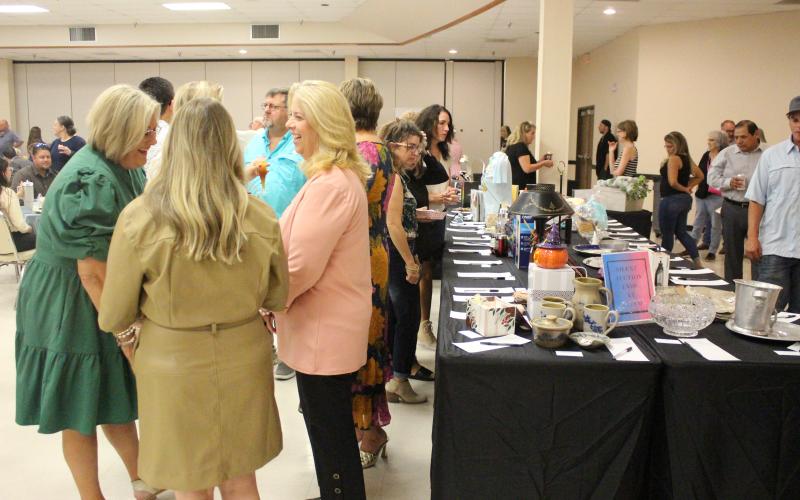Sentinel Photo/Jessica Shepard Matagorda County Museum's annual "Gourmet Guys" fundraiser drew a crowd, not only for the food and beverage options, but for the silent auction items on Saturday, Sept. 30. This year's theme was "Charleston, South Carolina" and featured everything from smoked pig and boiled shrimp to fried green tomatoes and peach cobbler.