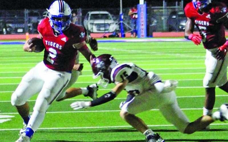 Sentinel Photo/Jessica Shepard Tidehaven running back Jachen Duran (2) stiff arms an East Bernard defender at last Friday contest at home.