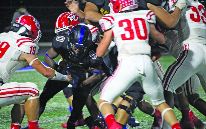 Sentinel Photo/Mike Reddell Junior running back Jada Andrews (0) barrels through the middle of El Campo defenders for yardage. Andrews had a game-high 161 yards rushing.