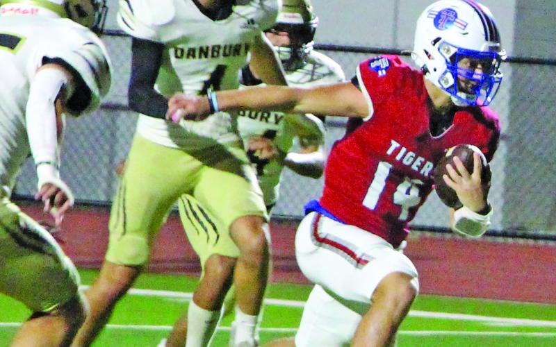 Sentinel Photo/Jessica Shepard At right, Tiger quarterback Kale Russell barrels through Danbury defenders en route to a Tidehaven touchdown.