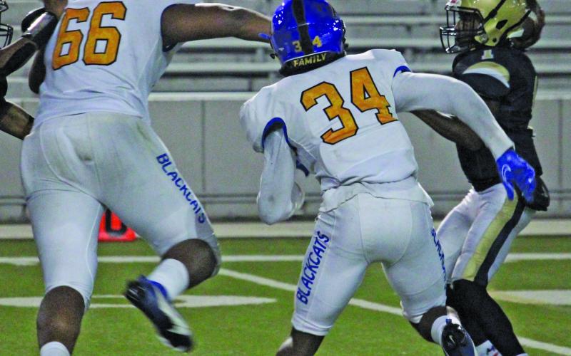 Sentinel Photo/Mike Reddell Senior Carlon Jones (66) and Cameron Spencer (34) pressure the North Forest quarterback.