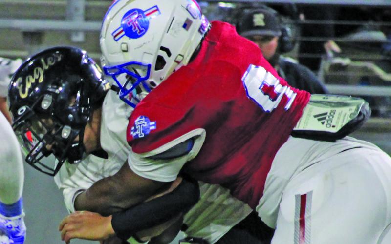 Sentinel Photo/Mike Reddell Tiger defensive end Darnell Butler brings down a Rogers running back.