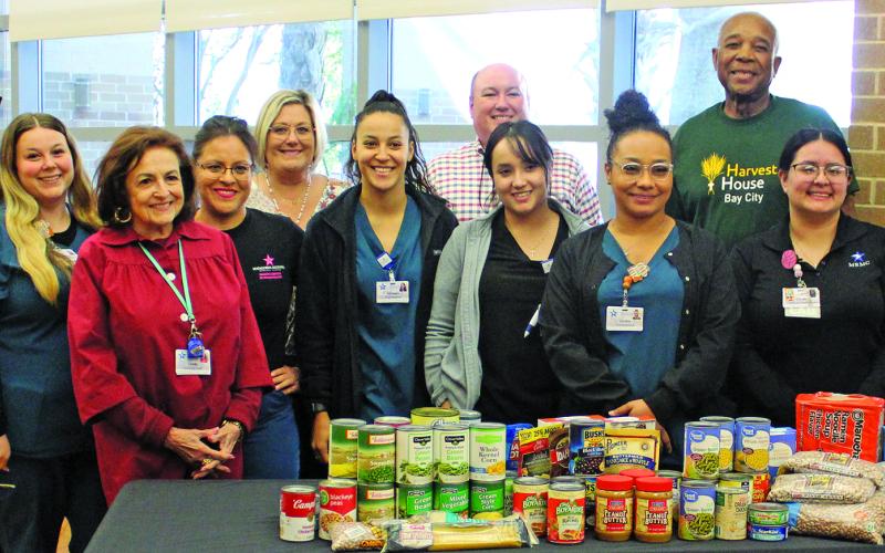 Sentinel Photo/Jessica Shepard Matagorda Regional Medical Center staff poses with a variety of non-perishable food and hygiene donations with Harvest House Volunteers Nov. 15. The hospital is hosting a food drive for donations to the local food pantry until Dec. 15.