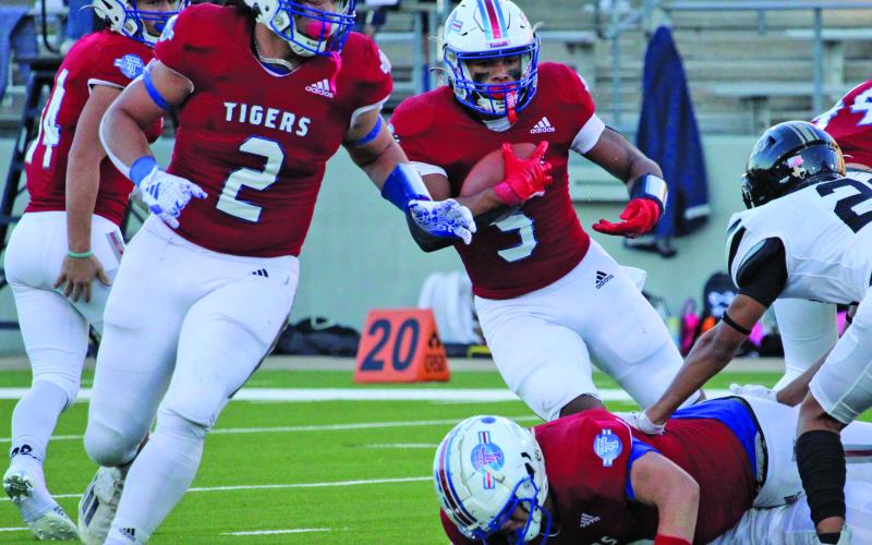 Sentinel Photos/Mike Reddell Tiger back Jachen Duran (2) prepares to block for back Josphen Dodds (5) to gain yardage against Rogers.