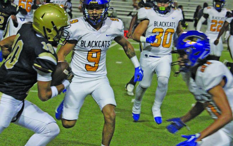 Sentinel Photo/Mike Reddell Blackcat defeners Isaiah Gonzales (9), and Michael Franklin (21) confront a North Forest runner, with Daniel Gonzales (30) coming in to help.