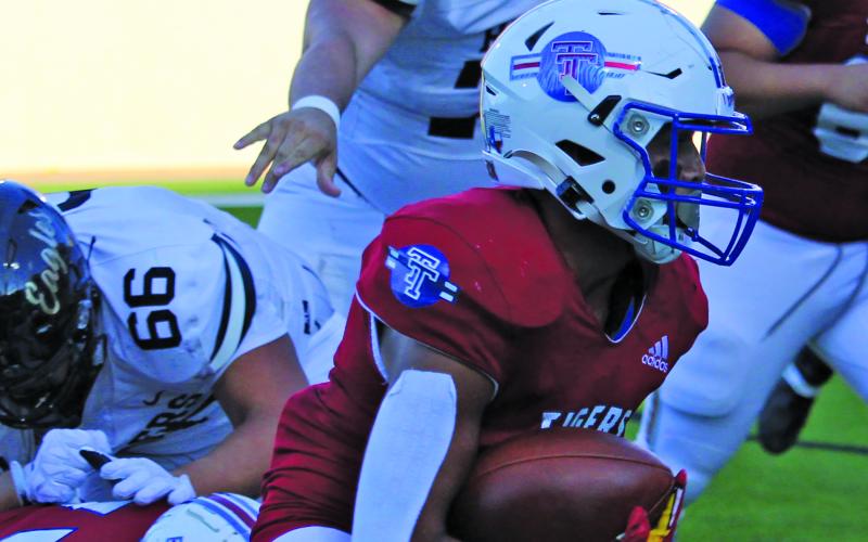 Sentinel Photo/Mike Reddell Tidehaven back Ricky Rubio (1) picks up yardage against the Eagles.