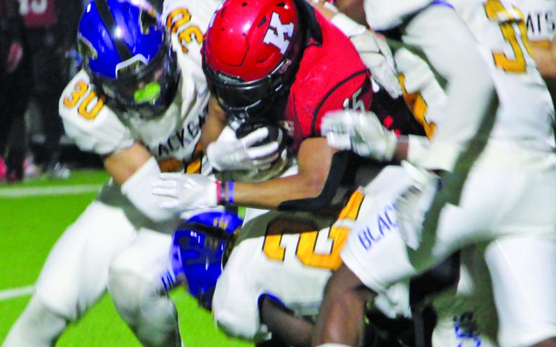 Sentinel Photo/Mike Reddell Senior linebacker Daniel Gonzales (30), sophomore linebacker James Copeland (22) and junior defensive end Cameron Spencer (34) stop a Bulldog runner. 