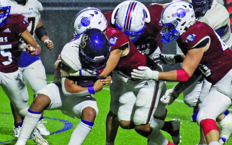 LeDarion Stone/Live in the Moment Photography Several Tidehaven tacklers bring a Buffalo back’s run to a halt.