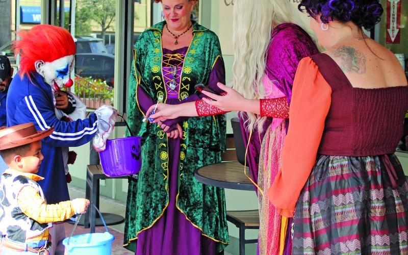 Sentinel Photo/Jessica Shepard Trick-or-treaters got to see the famous trio known as the Sanderson Sisters Witches up close at The Farmhouse Face &amp; Merchantile during "Trick or Treat Around the Square" Oct. 31. Many downtown businesses featured costumed employees along with their free candy distribution efforts.