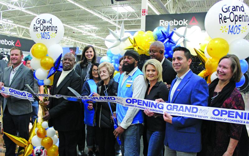 Sentinel Photo/Jessica Shepard Bay City Walmart partnered with the Bay City Chamber of commerce to celebrate its "Grand re-opening" with a ribbon-cutting ceremony on Friday, Nov. 3. Walmart employees with over 30 years in the company were on hand to help cut the ribbon align with store and city officials.