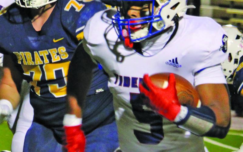 Sentinel Photo/Mike Reddell Tiger senior running back Joseph Dodds (5) gains part of his 225 yards rushing against the Pirates. Dodds had three rushing touchdowns and caught a scoring pass.