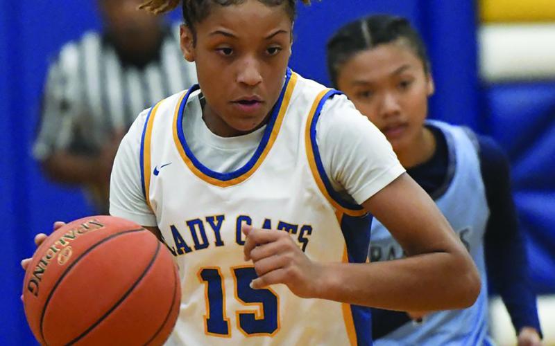 Larry Bose photo  Bay City senior Ladycat Khylee Perry dribbles down court in a recent game. The Ladycats won the Silver  Division Championship at the Rockport-Fulton Tournament on the Coast. The Ladycats 7-7 were to play Van Vleck Tuesday.