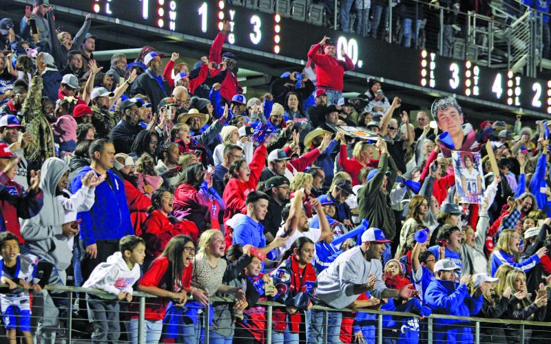 Sentinel Photo/Mike Reddell As they rallied for the Tidehaven football team against Daingerfield at New Caney ISD Stadium last week, the Tiger parents, relatives and fans will travel - some by caravan - to Arlington for the state title game with Gunter Thursday, Dec. 14.