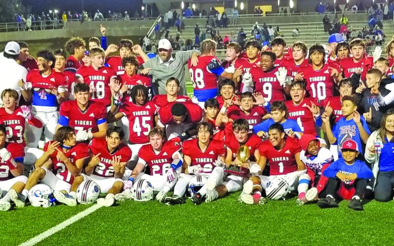 Sentinel Photo/Mike Reddell Victorious Tigers are joined celebrating the win over Daingerfield by coaches, Tidehaven administrators, cheerleaders and fans.