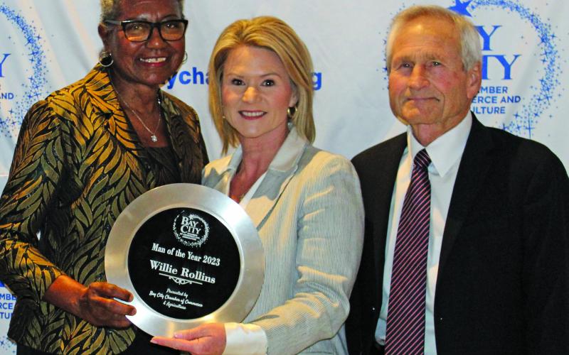 Sentinel Photo/Jessica Shepard Audrey Rollins, left, accepts the award for Man of the Year in behalf of her late husband Willie Rollins from Danyel Biggerstaff, outgoing board chair, and Arthur Milberger, 2021 recipient of the honor.