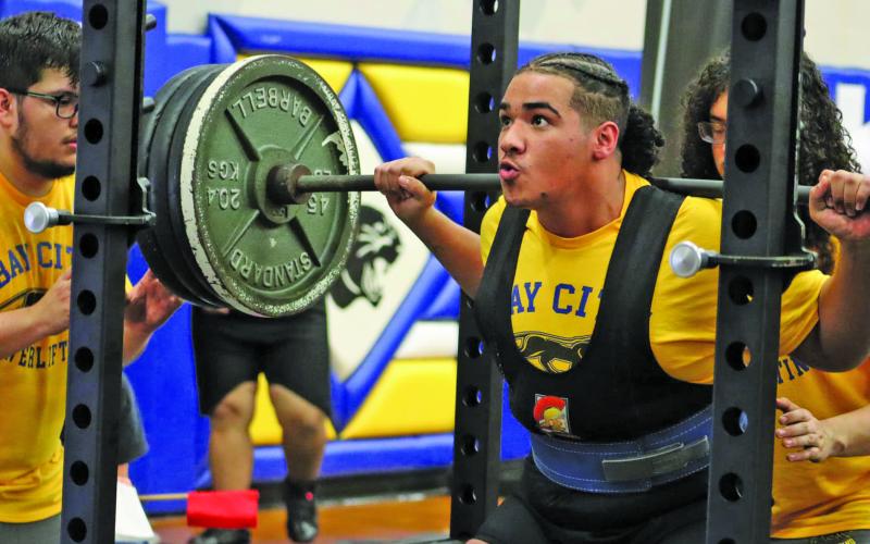 LeDarion Stone/Live in the Moment Photography Above Blackcat strains at performing the squat at BCHS Powerlifting Tournament Saturday, Jan. 13.