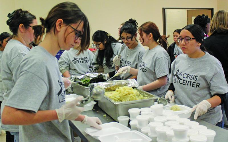 Sentinel Photo/Jessica Shepard Volunteers prepare meals for the Crisis Center’s fundraiser Chicken Fried Steak dinner Friday at the Civic Center.