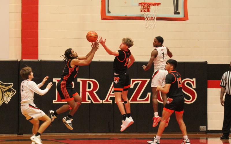 Photo by Anna Hernandez Leopard defense was in full effect against Brazos and both Van Vleck No. 11 Keemer Allums and No. 21 Micah Burks go up.t