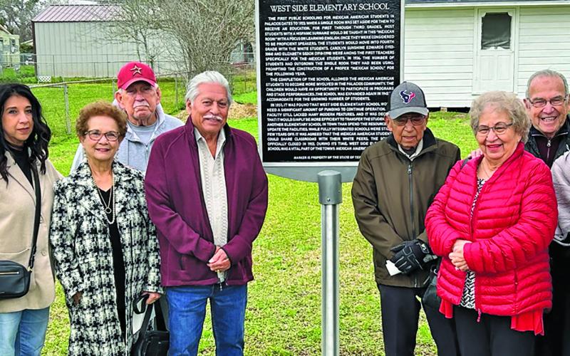 Top: The group picture with marker includes former students and children of students.