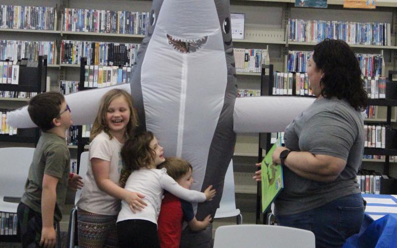Sentinel Photo/Jessica Shepard Sharky made an appearance at Bay City Public Library’s “Take your Child tot he Library” event, Saturday, Feb. 3. Children and parents were treated to a shark storytime and craft.