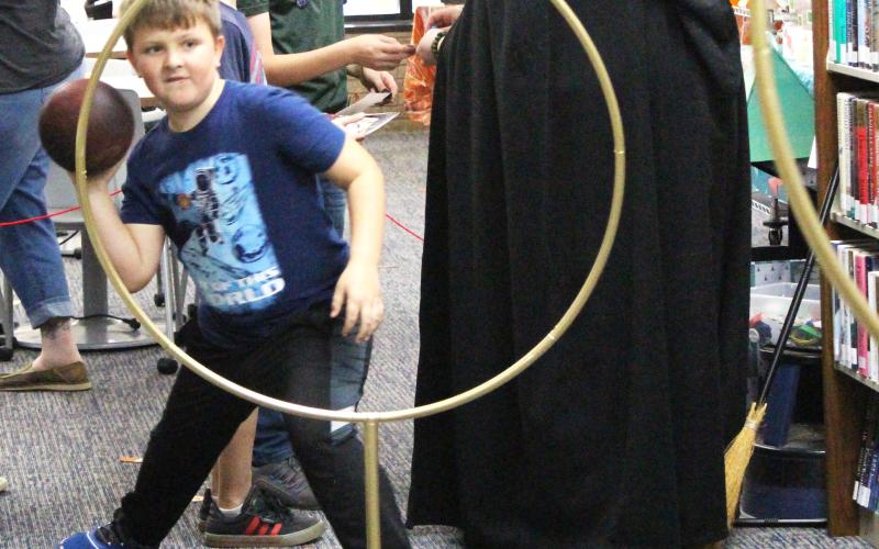 Fans of Harry Potter filled the Bay City Public Library to experience a sample of the wizarding world last week. Attendees were able to pick their own wands, mix a potion to increase their luck, get sorted into their Hogwarts house, and even play Quidditch (left). Sentinel Photo/Jessica Shepard