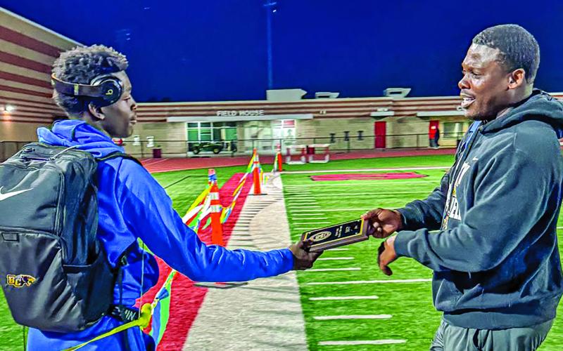 Contributed photo Blackcat trackster Xylan Williams, left, receives the MVP Award from Head Track Coach and Head Football Coach Robert Jones at the District track meet last week