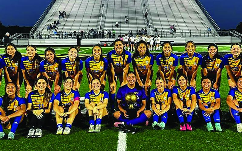 LeDarion Stone/Live in the Moment Photography The Lady Cats show off their area trophy after defeating La Vega last week.
