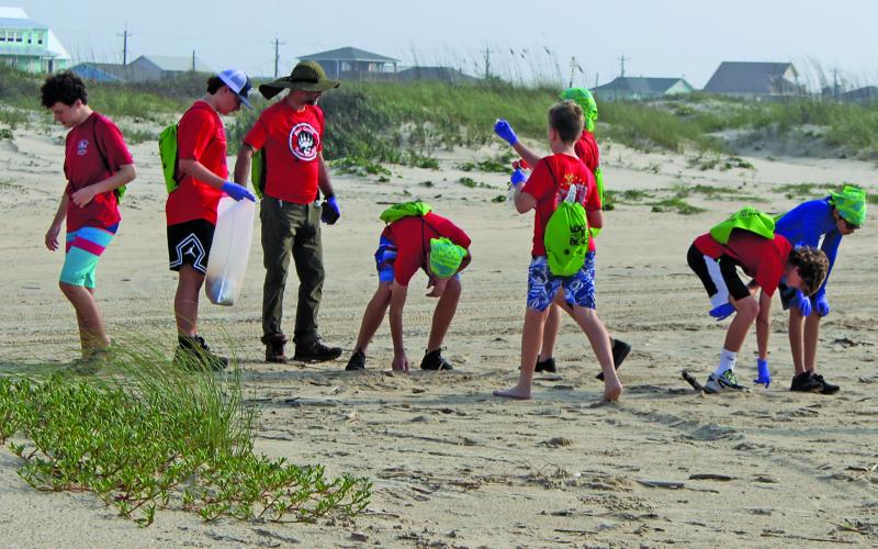 Boy Scout Troop 828 from Sugar Land lent a hand picking up trash along Matagorda Beach during the annual Adopt-A-Beach Cleanup Saturday, April 20. The troop camped out on the beach the night prior and joined other local groups for the cleanup after their breakfast. Sentinel Photo/Jessica Shepard