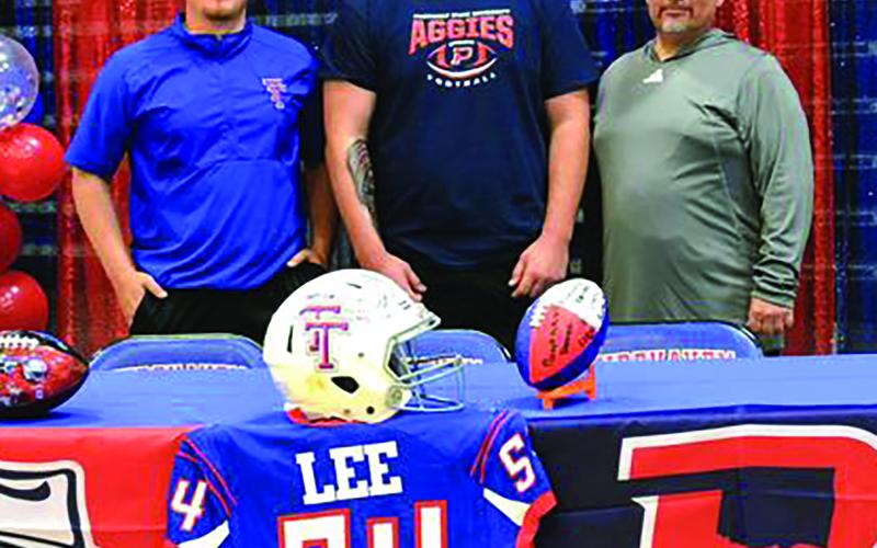 Contributed photo Tidehaven senior defensive tackle Wyatt Lee signed a letter of commitment last week with Oklahoma Panhandle State University in Goodwell, Okla. Wyatt is flanked by Coach Eric Lucio, left, and Head Coach David Lucio.