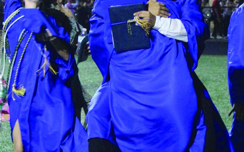 Sentinel Photo/Jessica Shepard Bay City High School's 216 graduating seniors shared their excitement with each other in various easy form hugs to striking energetic poses May 24.