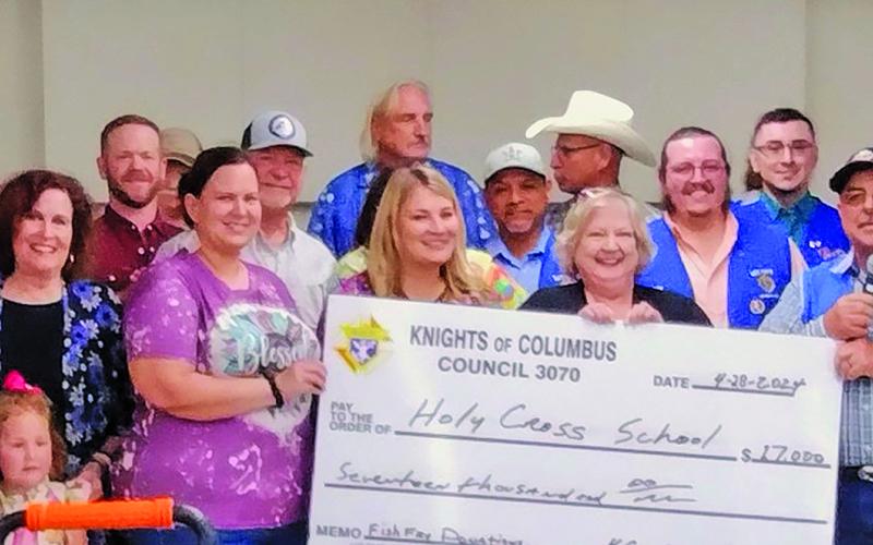 Rhonda Westbrook photo Holy Cross Catholic School received a $17,000 check from Bay City Knights of Columbus Council 3070 from this year's "Lenten Catfish Fries." The check was presented to HCCS's principal, Linda Bradford, at the annual HCCS Spring Bazaar on April 28.