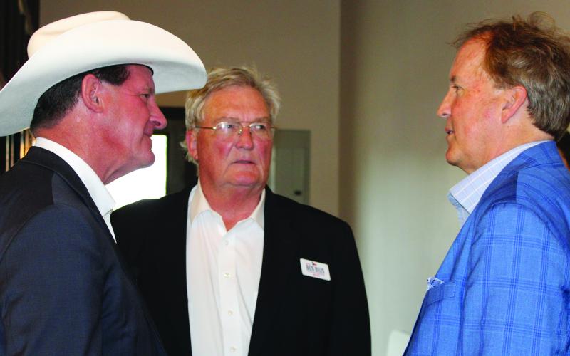 Sentinel Photo/Jessica Shepard  At left, Republican run-off candidate District 30 State Rep. AJ Louderback greets Attorney General Ken Paxton, right, at a support-fundraiser last week. Paxton arrived via plane with Republican run-off candidate District 12 State Rep. Ben Bius, center.