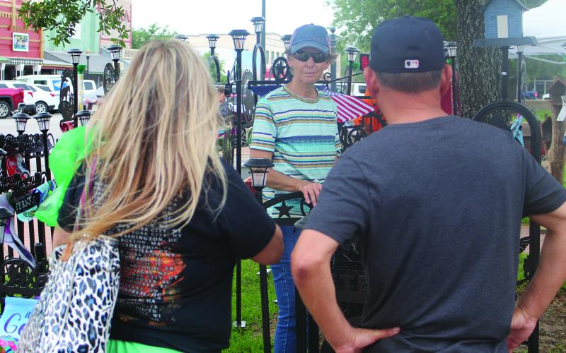 Sentinel Photo/Jessica Shepard Matagorda County Trade Days brought plenty of foot traffic downtown on Saturday, April 27. While there were a few new vendors, many of the returning ones braved gusting winds, like this yard art seller discussed customizing options with several customers.