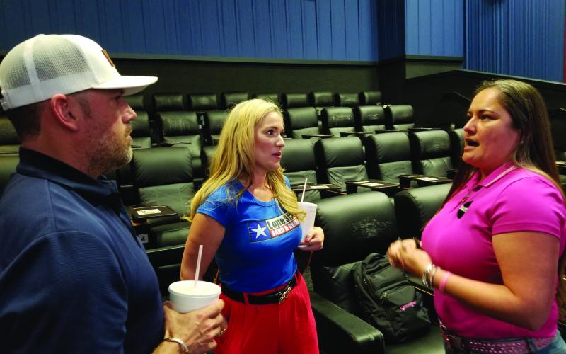 Sentinel Photo/Mike Reddell Stephanie Hajducek, right, talks with Trent and Tammi Tinnin about helping girls with career exploration and workforce development last week.