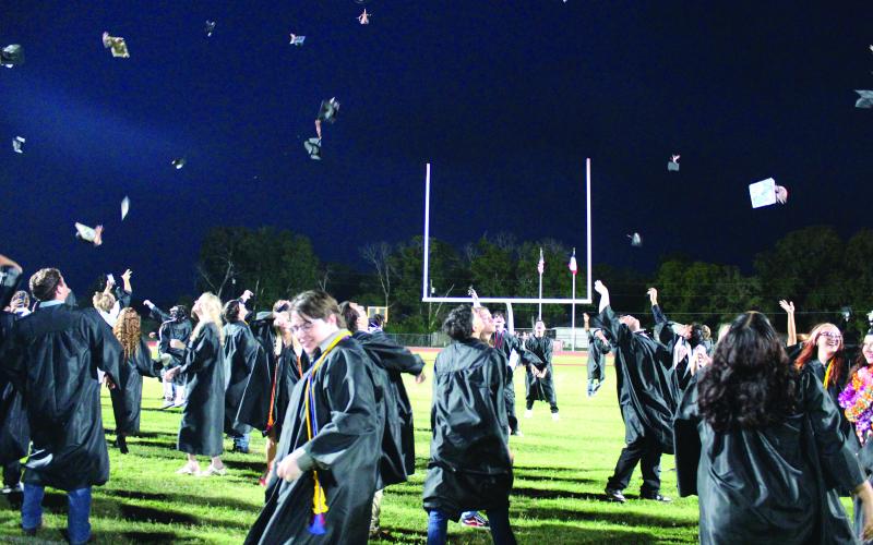 Sentinel Photo/Jessica Shepard Van Vleck graduates hustled to the south end of the football field to toss their caps to celebrate their commencement Thursday, May 23.
