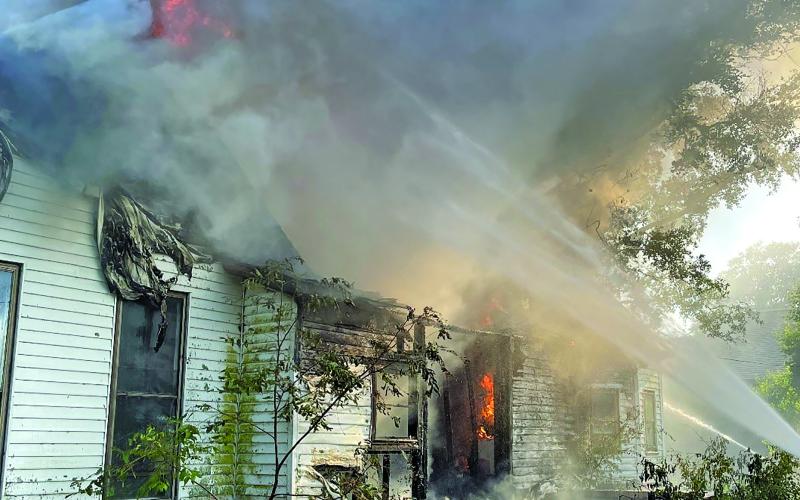 Dan Shook photo Firefighters keep a steady stream of water on a fire at vacant house at 155 Janise.