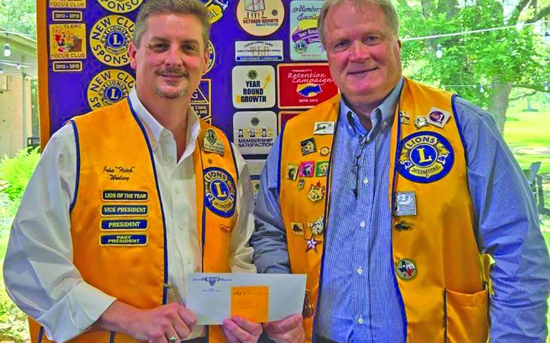 Bay City Lions Cluib President Bobby Seiferman presented Lion John Woolsey with the Wharton County Junior College Vocational Program a $3,000 scholarship check for the new carpentry school. Contributed photo