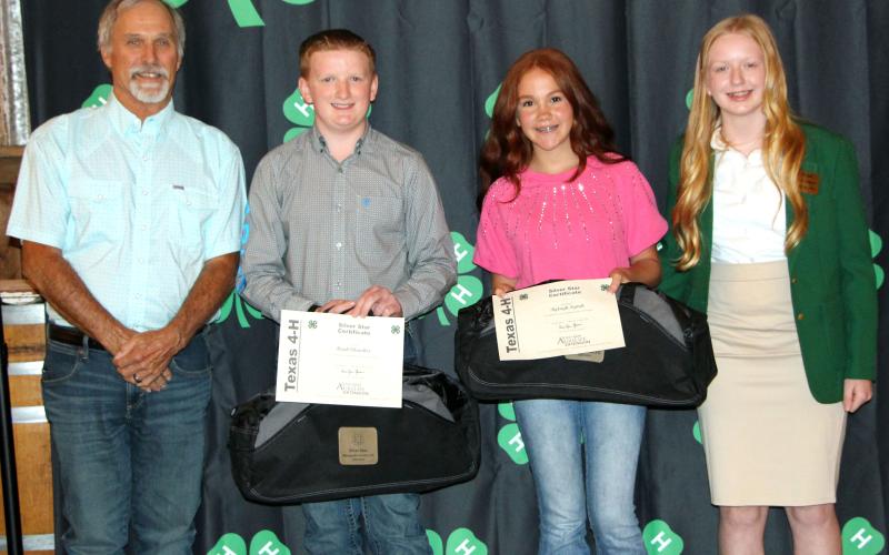 Sentinel Photo/Jessica Shepard Silver Star awards were given to Hank Chandler and Ryleigh Siptak, above with Precinct 1 Commissioner Bubba Cook, left, and 4-H Ambassador Lily Chandler, right.